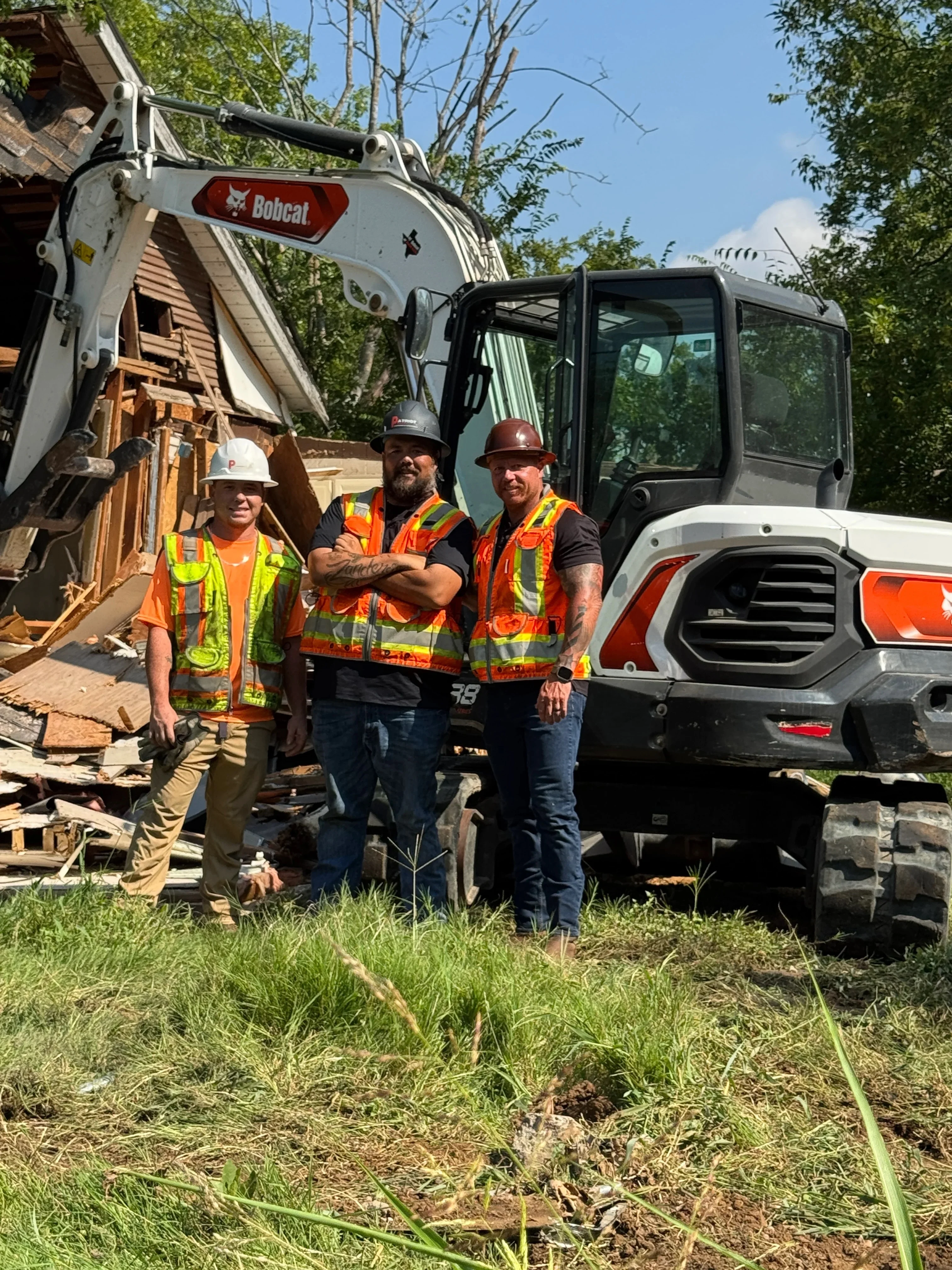 Heavy equipment and crew tools ready for excavation and land clearing work on a job site.