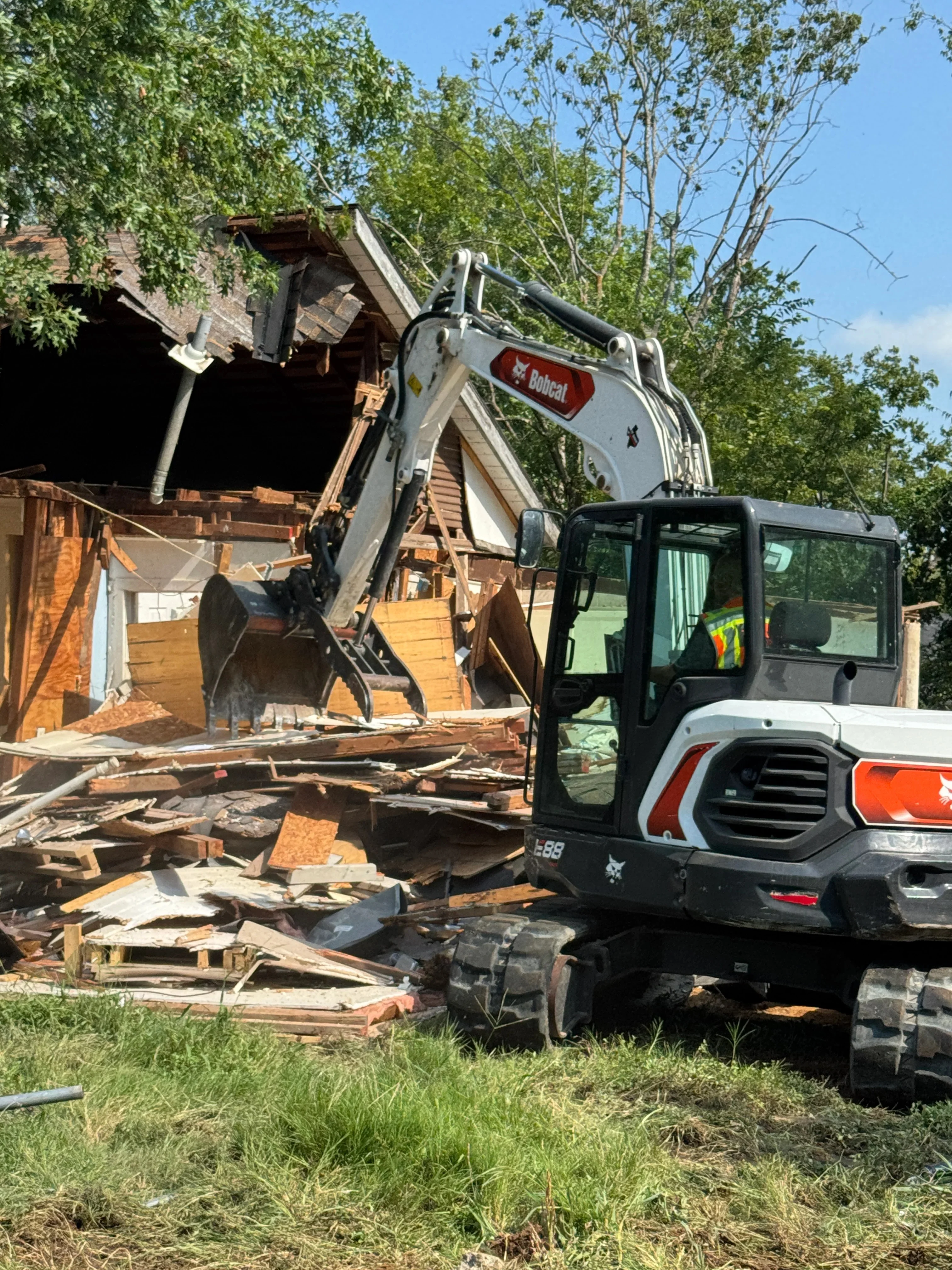 Demolition equipment removing concrete and debris from a construction site