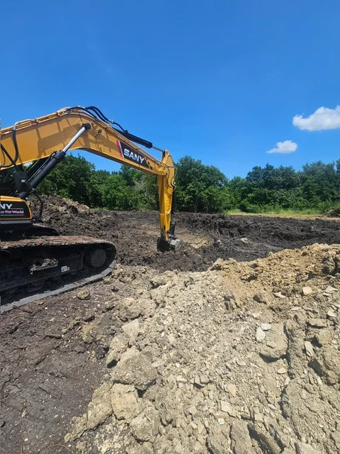 SANY excavator moving earth and aggregate materials at active excavation site